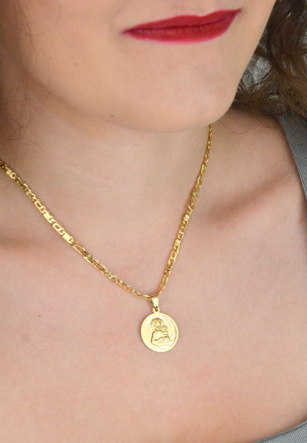 Złota zawieszka próby 585 z wizerunkiem Matki Boskiej z Dzieciątkiem. Wymiary 2 cm, waga 2,63 g. Klasyczny medalik religijny w eleganckiej formie.1.jpg